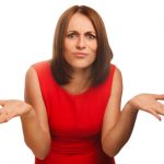 dissatisfied angry young woman haired girl in red dress emotion isolated on white background